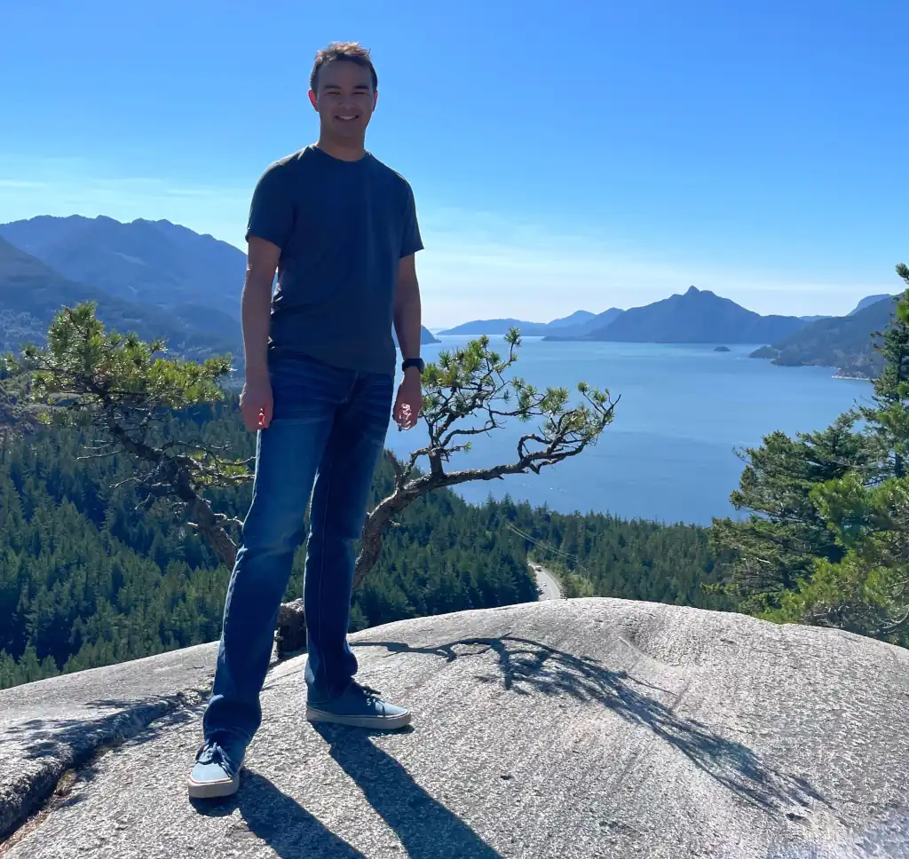 Jade standing on a small mountain.